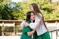 Mom and teenage daughter hugging on walk in park Royalty Free Stock Photo