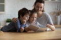 Happy mom and two sibling kids involved in fairy tale Royalty Free Stock Photo