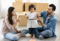 Happy moment family eating chocolate cookie in living room at home. Father Mother and daughter laughing having a good meal in the Royalty Free Stock Photo