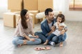 Happy moment family eating chocolate cookie in living room at home. Father Mother and daughter laughing having a good meal in the Royalty Free Stock Photo