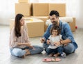 Happy moment family eating chocolate cookie in living room at home. Father Mother and daughter laughing having a good meal in the Royalty Free Stock Photo