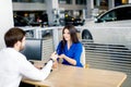 Attractive european woman receiving car keys from car sales agent Royalty Free Stock Photo