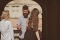 Happy moments. Bearded man and pretty women smiling on street. Bonds of friendship. Boyfriend dating girlfriends. People