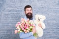 Happy moments. Love date. happy international holiday. happy bearded man with tulip bouquet and bear. Flower for March 8