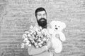 Happy moments. Love date. happy international holiday. happy bearded man with tulip bouquet and bear. Flower for March 8