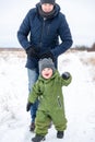 Happy moments of the son and father walking in the winter in the field. Family lifestyle. Royalty Free Stock Photo
