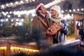 Happy moments of young couple in love at christmas festival in the city. Festival, love, relationship, Xmas, snow