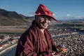 A happy monk in Yaqing Temple in the sunset