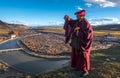 A happy monk at Yaqing Temple in the sunset