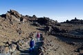 Happy morning children descend from the Teide volcano in the Canaries, petrified lava, lava valley, natural background, against