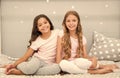 Happy morning. Children in pajamas. Stay at home. Pajamas all day. Cute cozy bedroom for small girls. Sisters having fun Royalty Free Stock Photo