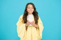 Happy morning. Comfy outfit for weekend rest at home. Comfy style. Kid wearing soft poncho drinking tea. Little girl Royalty Free Stock Photo