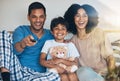 Happy, morning and a family watching tv on bed in their home together for streaming or entertainment. Parents, children Royalty Free Stock Photo