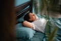 Happy morning. Portrait of a pretty young woman relaxing on bed with hands under her head. Royalty Free Stock Photo