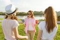 The happy mother is actively resting on nature with her teenage daughters 14 and 16 years old. Communication of parents and teenag Royalty Free Stock Photo