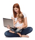 Happy mother with adorable little girl and laptop Royalty Free Stock Photo