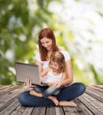Happy mother with adorable little girl and laptop Royalty Free Stock Photo