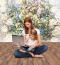 Happy mother with adorable little girl and laptop Royalty Free Stock Photo