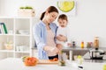 Happy mother and baby cooking food at home kitchen Royalty Free Stock Photo