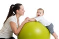 Happy mother and baby making healthy gymnastics on fit ball Royalty Free Stock Photo