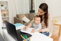 Happy mother with baby and papers working at home Royalty Free Stock Photo