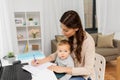 Happy mother with baby and papers working at home Royalty Free Stock Photo