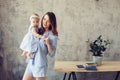 Happy mother and baby playing at home in bedroom Royalty Free Stock Photo