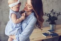 Happy mother and baby playing at home in bedroom Royalty Free Stock Photo