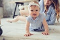 Happy mother and baby playing at home in bedroom Royalty Free Stock Photo