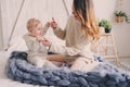 Happy mother and baby playing at home in bedroom. Cozy family lifestyle Royalty Free Stock Photo