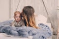 Happy mother and baby playing at home in bedroom. Cozy family lifestyle Royalty Free Stock Photo