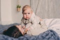 Happy mother and baby playing at home in bedroom. Cozy family lifestyle Royalty Free Stock Photo