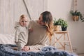 Happy mother and baby playing at home in bedroom. Cozy family lifestyle Royalty Free Stock Photo