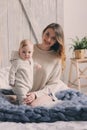 Happy mother and baby playing at home in bedroom. Cozy family lifestyle Royalty Free Stock Photo