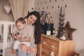 Happy mother and baby son playing together at home. Happy family lifestyle concept in real life interior Royalty Free Stock Photo