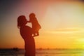 Happy mother and baby at sunset beach Royalty Free Stock Photo