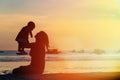 Happy mother and baby at sunset beach Royalty Free Stock Photo