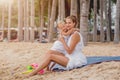 Happy mother and baby on the sunset at the beach. Royalty Free Stock Photo