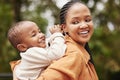 Happy mother bonding with cute baby boy on piggyback while smiling, laughing and having fun play in a park outdoors Royalty Free Stock Photo