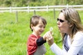 Happy mother and boy blowing dandelion Royalty Free Stock Photo