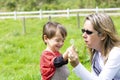 Happy mother and boy blowing dandelion Royalty Free Stock Photo