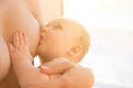 Happy mother breast feeding her baby infant Royalty Free Stock Photo