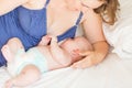 Happy mother breast feeding her baby infant Royalty Free Stock Photo