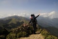 Happy Mother carrying child on top of mountain