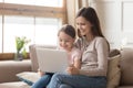 Happy mother and child daughter use laptop computer at home Royalty Free Stock Photo
