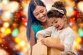 Happy mother and child girl with gift box Royalty Free Stock Photo