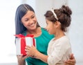 Happy mother and child girl with gift box Royalty Free Stock Photo