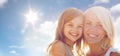 Happy mother and child girl over sun in blue sky Royalty Free Stock Photo