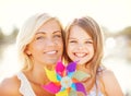 Happy mother and child girl with pinwheel toy