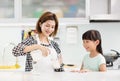 Mother and child in kitchen drinking milk Royalty Free Stock Photo